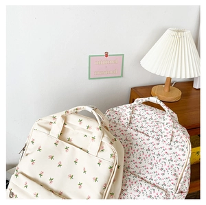 Close-up of floral pattern backpacks on wooden furniture with a warm lifestyle setting