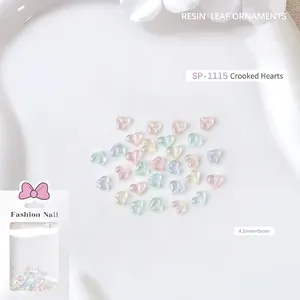 Macro detail of 4.5mm resin nail art charms featuring colorful aurora glitter hearts