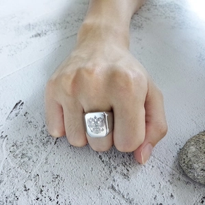 Close-up of a silver stainless steel signet ring with a double-headed eagle emblem