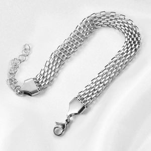 8mm wide silver braided metal chain bracelet with extension chain on white silk