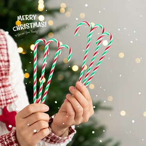 Set of six red, green, and white candy cane ornaments held against a warm Christmas tree background