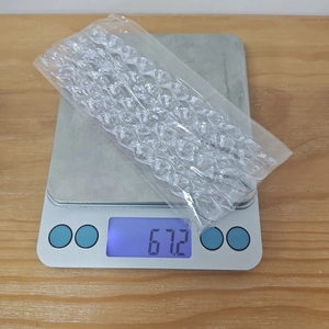 Close-up of clear acrylic icicle ornaments on a scale showing product weight detail