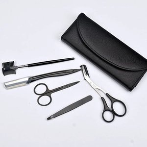 Detailed view of 5-piece black eyebrow grooming kit with stainless steel tools and PU case