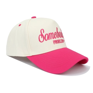 Detailed close-up of pink 'Somebody's PROBLEM' embroidery on a cream trucker hat