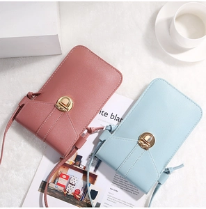 Detail of pink and blue mini crossbody phone bags with textured leather and gold locks