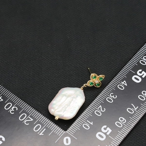 Baroque pearl drop earrings with golden four-leaf clover and sparkling green gems
