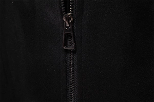 Detailed close-up of premium gunmetal rectangular zipper on black suede jacket