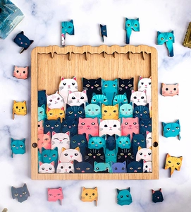 Detailed top view of colorful wooden cat puzzle pieces on a marble surface background