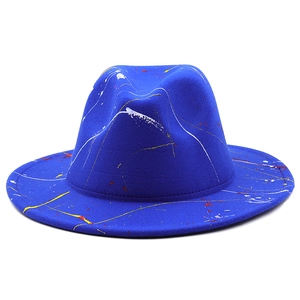 Detail of royal blue fedora hat with unique artistic paint splatter and fine stitching