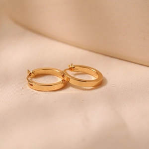 Macro shot of 18K gold plated hoop earrings showing flat cross-section and polished finish