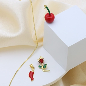 Golden necklace set featuring cherry, rose, and chili pendants with red and green enamel