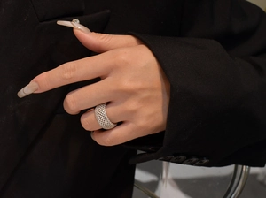 Close-up of wide mesh 925 silver ring with micro-pave crystals on female hand