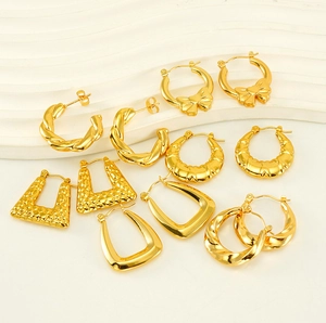 Macro shot of gold-plated titanium steel earrings in diverse geometric patterns and styles