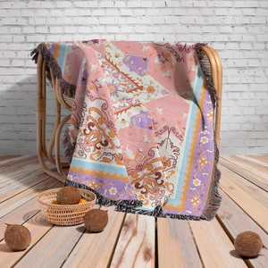 Close-up of bohemian woven blanket with vibrant geometric patterns and colorful tassels