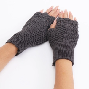 Detailed knit texture of dark grey fingerless gloves in a cross-hand pose for women