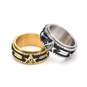 Macro detail of rotating Masonic rings in gold and silver finish with engraved G logo