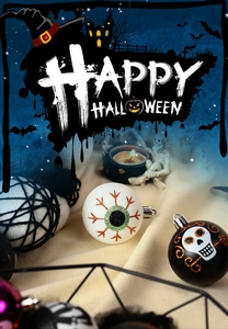 Detail of Halloween decorative balls with ghost eyes and skull patterns in black and white