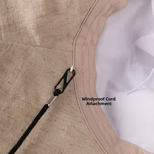 Detail view of the detachable windproof rope hook on linen sun hat interior lining