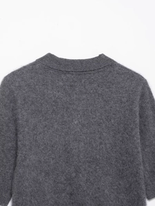 Detail shot of dark gray knit polo sweater neckline with soft wool fiber texture