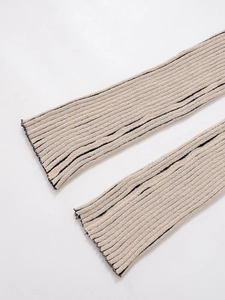 Detail shot of beige and black striped knit sleeves with ribbed texture and elastic finish