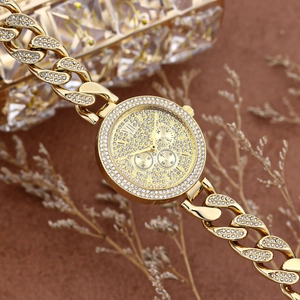 Macro shot of gold hip hop watch with iced out crystals and sparkling Cuban link band
