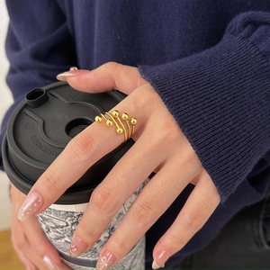 Detailed view of a multi-layer gold S925 silver ring featuring six polished beads on hand