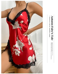 Detail of red satin nightdress with floral print and delicate black lace trim at side slit
