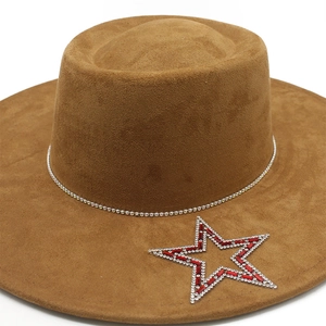 Detail of a brown suede jazz hat featuring star decoration and rhinestone band