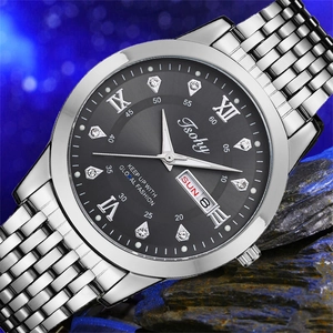 Macro view of silver stainless steel watch with black dial and dual calendar window
