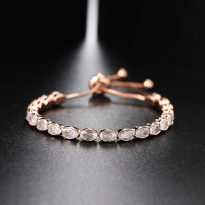 Detailed close-up of rose gold tennis bracelet with oval cubic zirconia and bolo clasp