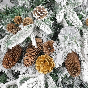 Natural Christmas pine cones set with gold and silver accents on flocked pine needles
