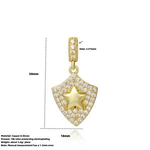 Detailed view of gold star shield pendant with dimensions 34mm x 18mm and zircon inlay
