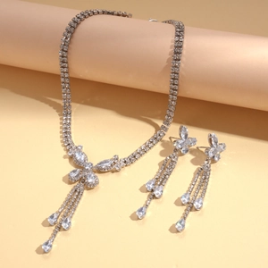Luxury zircon butterfly necklace and earrings set with tassel pendants on beige stand