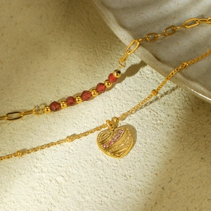 Golden double-layer stainless steel bracelet with red beads and a heart pendant