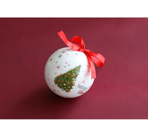 Detail of a white Christmas ball with red ribbon and Merry Christmas print on red background