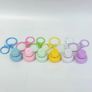 Row of six colorful mechanical fidget buttons with metal keychains on a white background