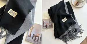 Close-up of double-sided cashmere scarf detail showing knit texture and fringe