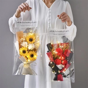 Detail of LED lit sunflower and carnation soap bouquets in gift bags with wishes