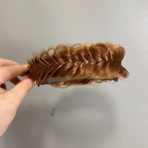 Macro detail of wide fishtail braid headband with non-slip grip in light brown hair