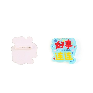 Acrylic badge with Good Thing motivational text and safety pin on white background