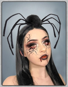 Detail of a large black plush spider headband for Halloween cosplay and gothic parties