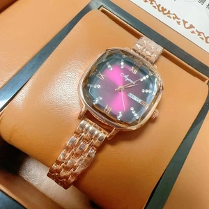Detail of rose gold square watch with purple gradient dial and date display window