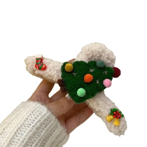 Festive Christmas elk hair claw clip with plush texture and holiday charms on white background