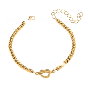 Detail of 4mm gold beaded bracelet featuring a heart love knot and lobster clasp closure