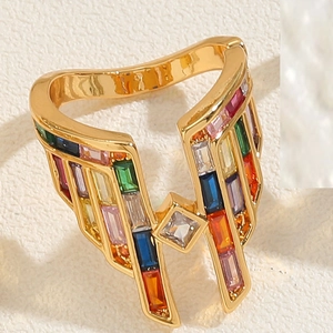 Macro shot of 14K gold plated ring featuring colorful rectangular zircon stones in wing design