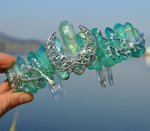 Macro detail of green crystal headband with silver moon and metal branch texture