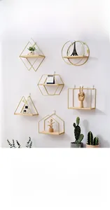 Detail of geometric gold iron wall shelves with wood base in Nordic minimalist style