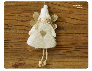Detail of plush angel ornament with gold sequin heart and wings on wood background