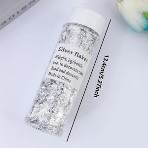 Macro detail of 2g silver flakes in a clear plastic bottle for cake decoration