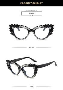 Detailed close-up of luxury black cat-eye glasses frame with sparkling white rhinestones